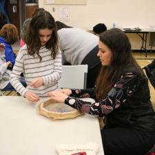 Grade 5 female student and her mother work on making her hand drum